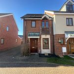 Modern two-storey brick house with driveway.