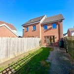 Two-storey brick house with fenced garden