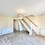 Empty room with stairs and wooden flooring