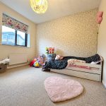 Cosy child's bedroom with toys and bed.