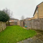 Back garden with fence and grass.