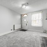 Bright living room with fireplace and window