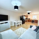 Modern open-plan kitchen and living room area.