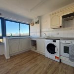 Modern kitchen with appliances and wooden flooring