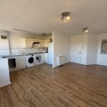 Open plan kitchen with wooden flooring