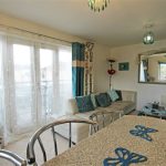 Bright living room with couch and balcony view.