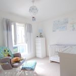 Bright baby room with cot and rocking chair.