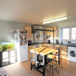 Modern kitchen with island and appliances.