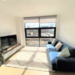 Bright modern living room with large window.