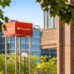 Santander building and logo with trees.