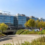 Modern office building with surrounding greenery.