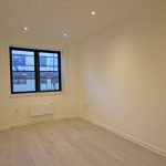 Empty room with wooden floor and window.