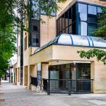 Modern office building on tree-lined street