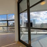 Modern flat with large windows and city view.