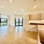 Modern open-plan kitchen and living space with large windows