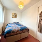 Cosy bedroom with double bed and chandelier.