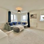 Modern living room with grey sofa and cushions.