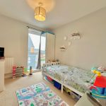 Children's bedroom with toys and bed.