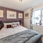 Cosy bedroom with purple butterfly wallpaper