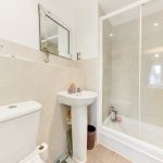 Modern bathroom with shower, sink, and toilet