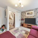 Cosy living room with red sofa and TV