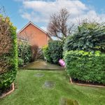 Lush garden pathway with trimmed hedges