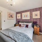 Cosy bedroom with purple butterfly wallpaper