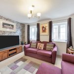 Cosy living room with modern decor and TV.