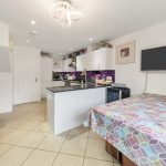 Modern kitchen with island and dining area.