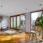 Bright studio with easels and paintings