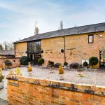 Stone barn conversion with courtyard and potted plants