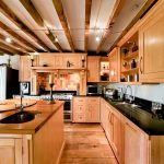 Spacious kitchen with wooden cabinets and island.