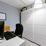 Modern office with desk, chair, and wardrobe