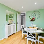 Modern dining room with mint green walls.