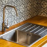 Modern kitchen sink with patterned tiles