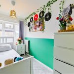 Bright bedroom with plants and vinyl records decor.