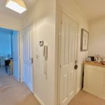 Interior hallway with decor and open doors.