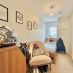 Cosy bedroom with helmet and framed art.