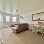 Bright living room with sofa and dining table.