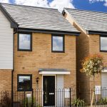 Modern brick house with blue sky background.