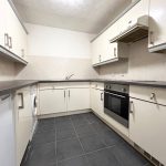 Modern kitchen with appliances and tiled floor