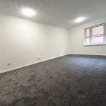 Empty room with carpet and large window