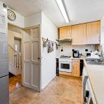 Modern kitchen with appliances and wooden cabinets.