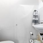 Small bathroom with sink and toilet.