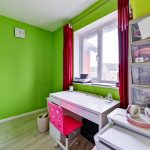 Bright home office with green walls and desk