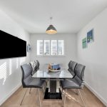 Modern dining room with table and chairs.