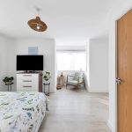 Bright bedroom with modern decor and natural light.