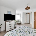 Modern bedroom with TV and floral bedding