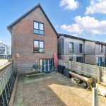 Modern brick house with fenced patio area