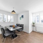 Modern dining room with grey chairs and table.